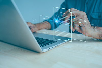 Hand typing on a laptop