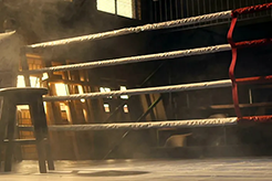 Dimly lit boxing ring